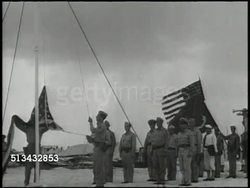 1945: OCCUPIED WAKE ISLAND: VS United States Major Colonel Walter Baylor (unconfirmed) arriving on Wake Island, various Japanese soldiers standing at attention, U.S. soldiers raising American flag, Japanese soldiers saluting. WWII surrender Instructional Video