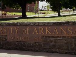 Drive by "Univeristy of Arkansas Founded 1871" signage Stock Footage