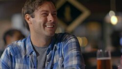 Young man sits at bar and chats with bartender Stock Footage