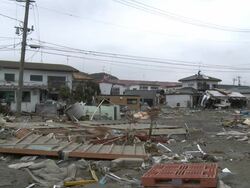 Destruction caused by tsunami after magnitude 9 Tohoku earthquake, north east Japan, March 2011. Wide shot of debris scattered across residential area Stock Footage