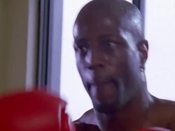 close up zoom out to MS shirtless Black male boxer sparring with speed bag in gym Stock Footage