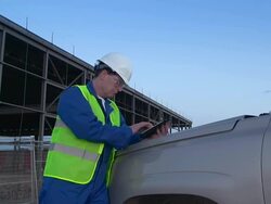 Engineer or job superintendent uses a tablet on construction site Stock Footage