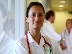 MS CU PAN Portrait of  female doctor and two doctors at background / Brussels , Brabant, Belgium Stock Footage