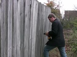 Man fixing a fence Stock Footage