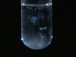Lead (II) chloride precipitate, formed as potassium chloride is dripped into lead (II) nitrate solution Stock Footage