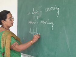 MS Lady teacher writing in English on green chalk board / Himachal Pradesh, India Stock Footage
