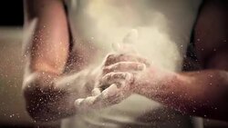 SLO MO Male gymnast clapping his chalky hands together Stock Footage