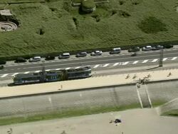 MS AERIAL TS View of Tram moving along Ostende beach / Flanders, Belgium Stock Footage