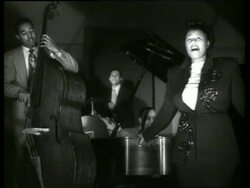 B/W Ella Fitzgerald singing with musicians Stock Footage