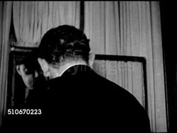 1920s: NEW YORK CITY: SPEAKEASY: HA WS People walking down into 21 Club entrance, MS Doorman shaking head. INT 21 Club w/ upscale people at bar, owners Charlie Berns, Jack Kreindler making note on check. Prohibition, 18th Amendment. Instructional Video