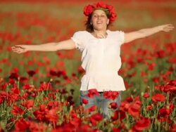 happy young woman on a poppy field Stock Footage