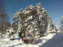 A young man snowboarding through trees and jumping over a playhouse. - Model Released - HD Stock Footage