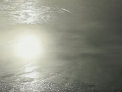 MS Reflection of cloud and sun migrates on surface of water / Iceland  Stock Footage