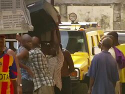 MS Shot of truck with people taking old televisions out of truck / Lagos, Nigeria Stock Footage