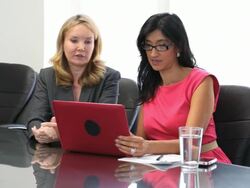 Businesswomen in conference room on laptop Stock Footage