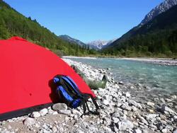 Backpacker Camping on River in the High Mountains Stock Footage