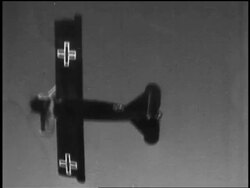 B/W 1910s AIR-TO-AIR World War I German biplane turning + diving toward clouds + ground Stock Footage