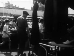 City of Treasures part 8 - children buy cradle at market. Market closing Paris 1951 Stock Footage