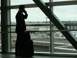 MS Well dressed young businessman standing and walking through airport with suitcase while traveling / Minneapolis, Minnesota, United States Stock Footage