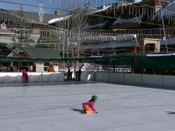 Lake Tahoe ice skating rink skater falls Stock Footage