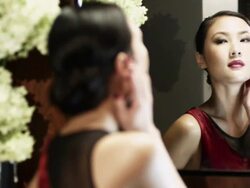 Young woman checking herself in mirror Stock Footage