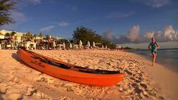 Tourists relaxing on Grand Cayman beach News Clip