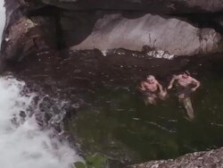 MS PAN Shot of Couple swimming in swimming hole on beautiful summer day in Northern / Maine, United States Stock Footage