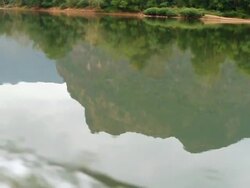 MS POV SLO MO Shot of travelling boat in river water with reflection of mountain / Mountain village near Muang Ngoi, Luang Prabang, Laos Stock Footage