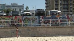 Pedestrians pass a wall of graffiti in Sydney, Australia. Stock Footage