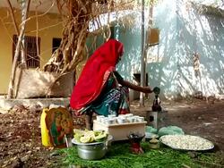 Ethiopian woman pouring coffee into pot Stock Footage