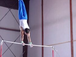 HD:Shot of Male Gymnast Performing Routine on Horizontal Bar Stock Footage