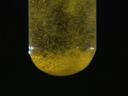 Lead (II) iodide precipitate, formed as potassium iodide is dripped into lead (II) nitrate solution Stock Footage