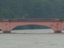 WS People biking and walking across bridge over the Ganges river / Haridwar, Uttarakhand,  India Stock Footage
