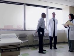 WS Three doctors standing in discussion in exam room/Seattle, Washington, USA Stock Footage