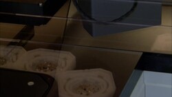 A machine moves watch components through a watchmaking factory in Switzerland. Stock Footage