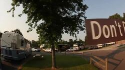 Road sign at campground boasts the famous words of Don't Be Cruel Lane Stock Footage