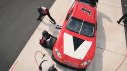 Stock car pit-crew refuels, jacks, and changes race-car tires Stock Footage