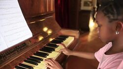 Young girl playing Piano Stock Footage