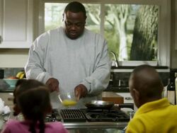MS Dad scrambling eggs and checking pan while  Daughter and son watching / Dallas, Texas, USA Stock Footage