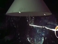 SLOMO CU light bulb under shade exploding Stock Footage