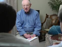 Senior Man Leads a Group Financial Discussion Stock Footage