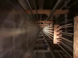 High Angle push-in - An elevator travels through a long shaft. / Shanghai, China Stock Footage