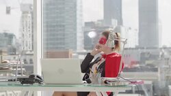 Superhero businesswoman talking on phone at desk Stock Footage