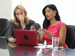 Two middle aged businesswomen, one adjust glasses Stock Footage