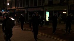 Police confronting rioters in London in early hours of Tuesday Instructional Video