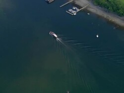 Aerial view zoom out boats on Derwent Water in the Lake District / house on island in the lake / Cumbria, England Stock Footage