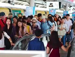 The escalators in the train station crowded with passengers for sky train Stock Footage
