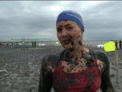 Competitors make a splash in muddy games News Clip