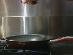 Egg drops in pan Stock Footage