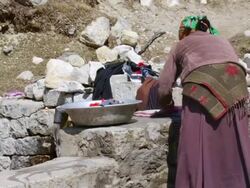 MS Shot of Sherpa woman doing laundry in Himalayas / SoluKhumbu, Nepal Stock Footage